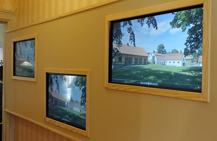 I gången in till utställningen rullar bilder från ön, här från Elfviks gård.